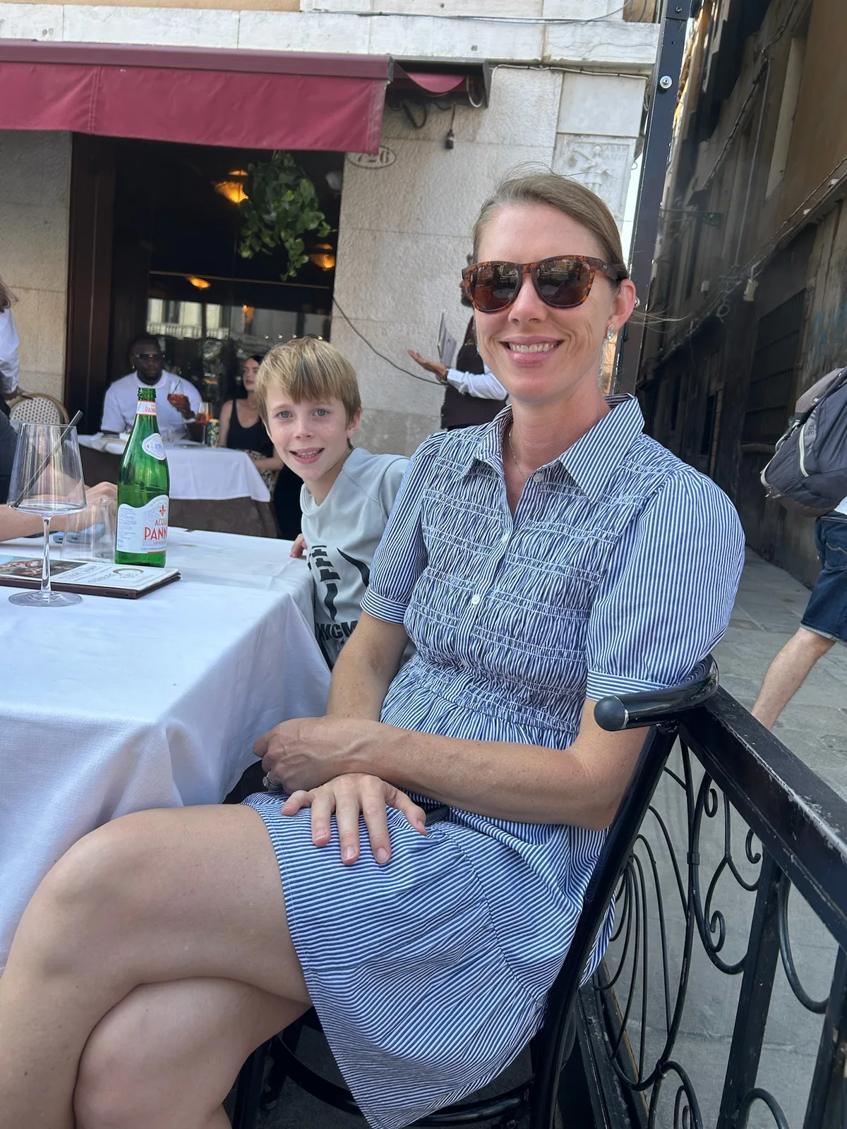 Angela seated at an outdoor restaurant