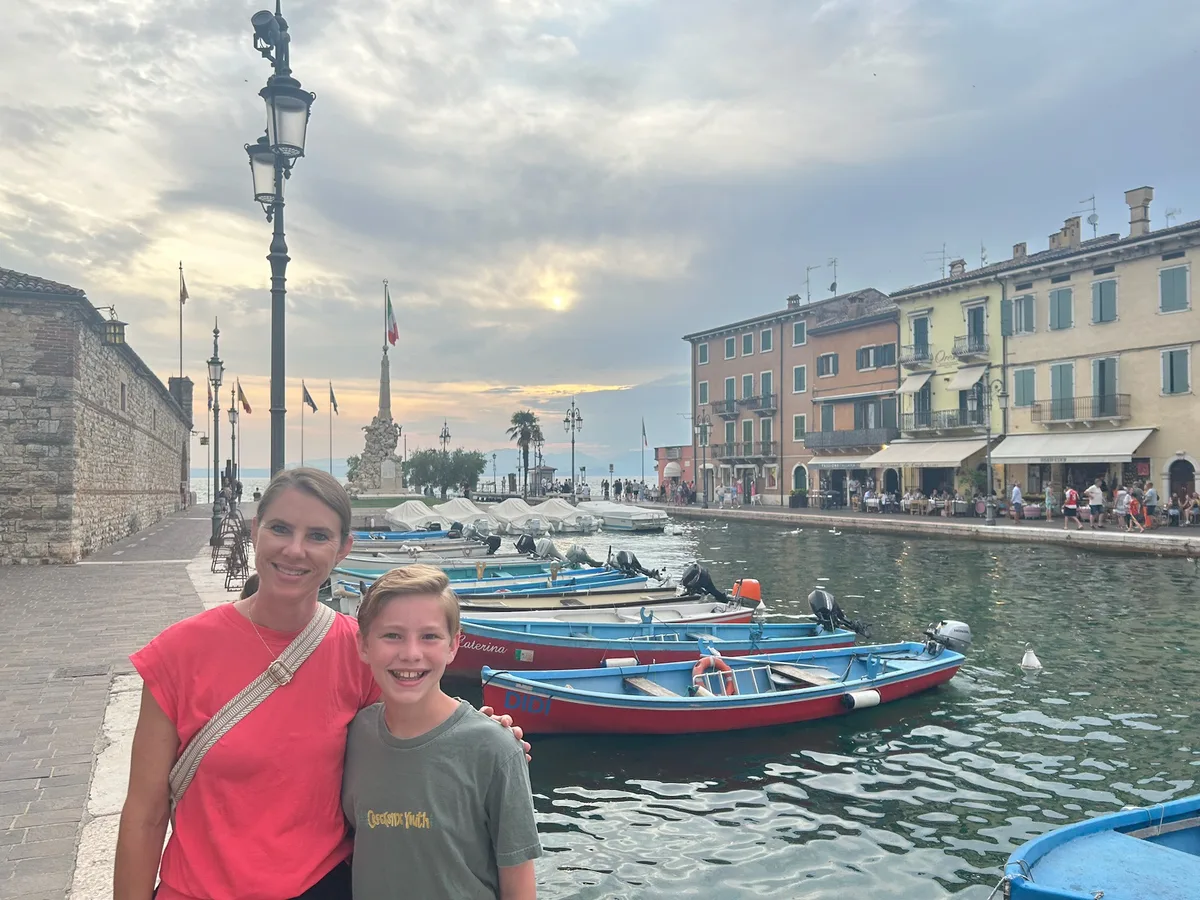 Angela and one of the boys beside boats on the Lake Garda waterfront