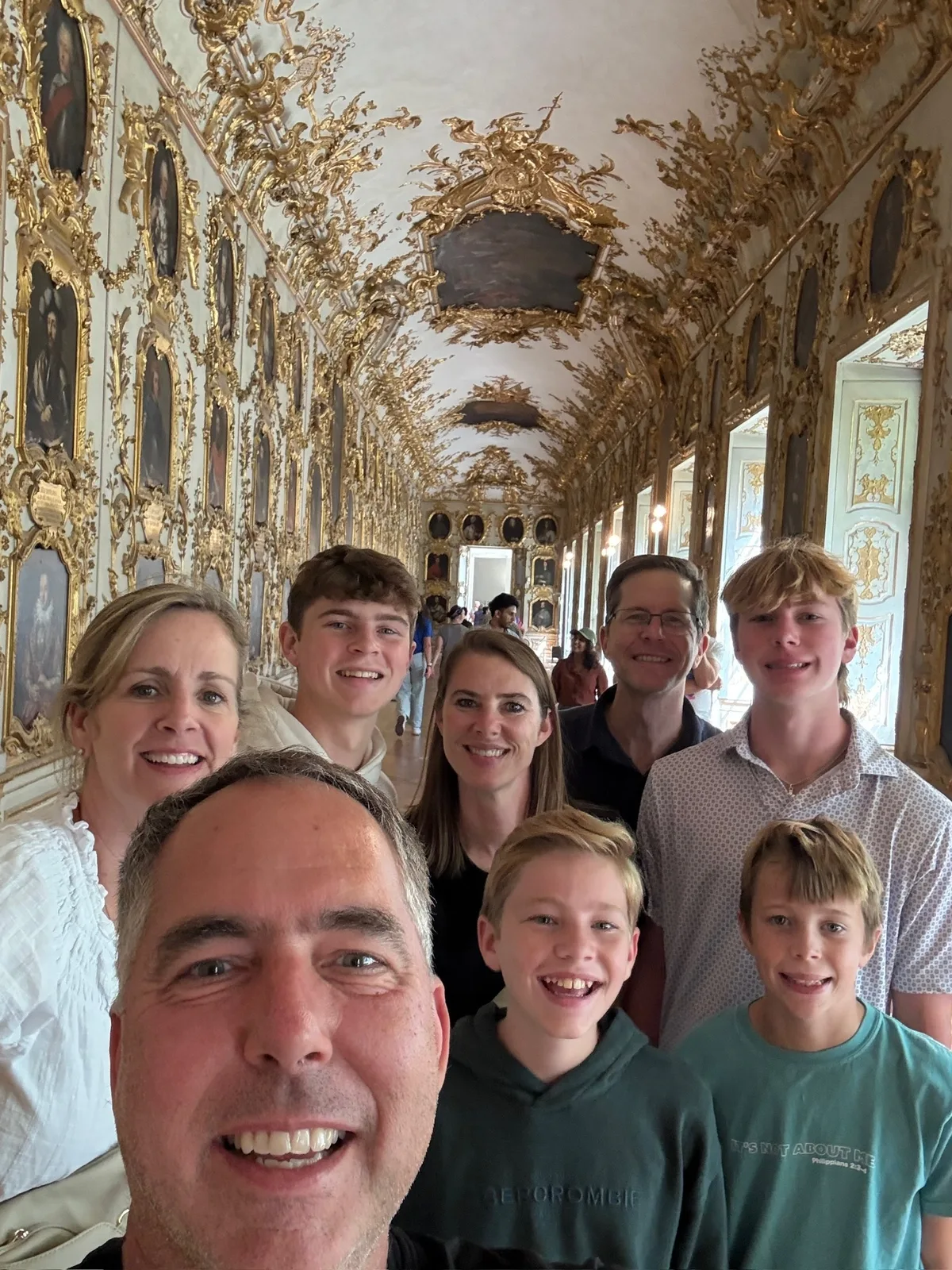 The family taking a selfie in an ornate palace gallery