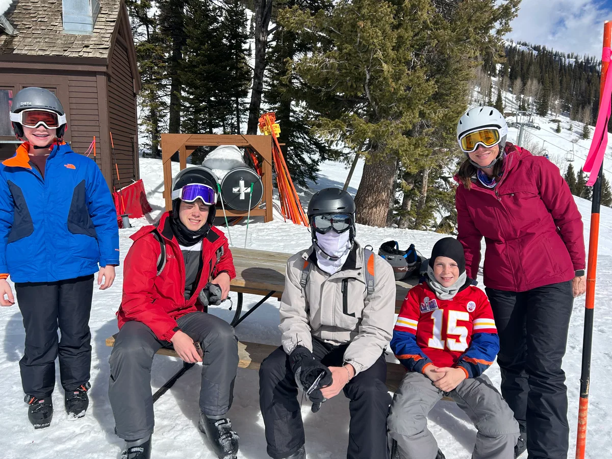 The family resting together beside their skis